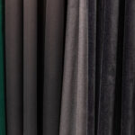 Set of dark multi-colored dense fabrics of uniform texture, choice of materials in different colors.